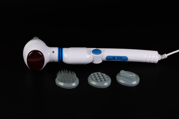 Electric infrared massage machine for the whole body and various attachments on a black background