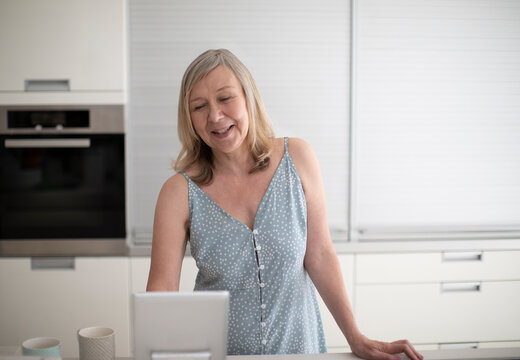 Senior woman using digital tablet in kitchen