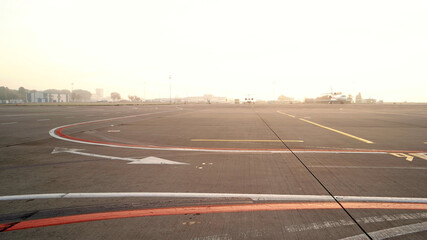 View of the airport aircraft parking at the terminal. Airplane on the runway. Aviation industry.