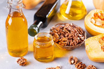 Bottles with different types of vegetable oil. Walnut oil and pumpkin oil.