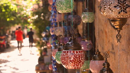 Turkish decorative lamps for sale at street market. Turkish mosaic lanterns hanging on the wall. Traditional souvenirs in old city of Antalya.
