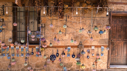 Building exterior with hanging colorful lanterns. Street market with traditional souvenirs at Antalya, Turkey.