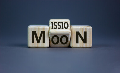 Moon mission symbol. Turned a cube with words 'Moon mission'. Beautiful grey background. Business, science and moon mission concept. Copy space.