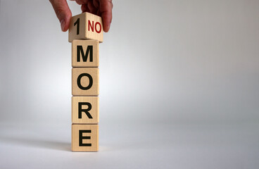 1 or no more symbol. Hand turns a cube and changes the words '1 more' to 'no more'. Beautiful white...
