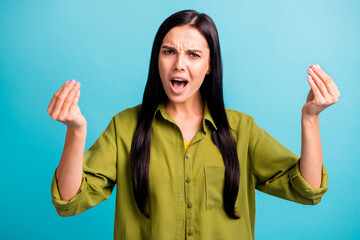Photo of offended angry girl raise arms open mouth look camera wear green shirt isolated blue color...