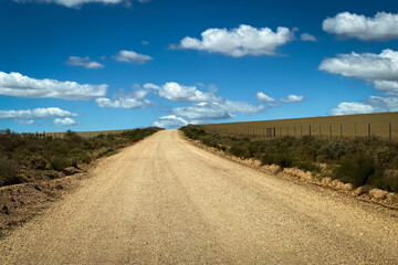 Fototapeta premium Scenic view of landscape and gravel road at Overberg district, South Africa.
