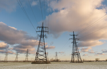 power lines in a winter wheat field during a beautiful sunset