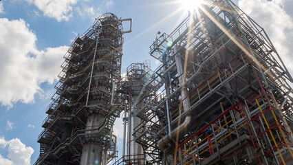 Refinery process area of petrochemical plant on classic blue sky with clouds background. Oil refining concept.