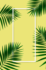 Exotic green tropical palm leaves isolated on yellow background with white geometric frame. Design for invitation cards, flyers. Abstract design templates for posters, covers, wallpapers with