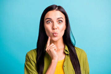 Photo of shocked young girl look camera funny face lips finger cheek wear green shirt isolated blue color background