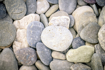 Smooth round large flat pebbles covering the whole image