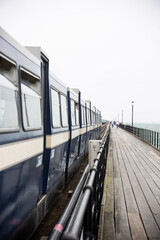 Train running along pier.