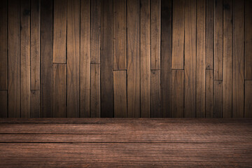 The empty space on the plank for displaying the product with the old brown wall background is dark. Wooden table surface with space