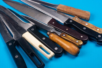 Several kitchen knives on the kitchen table close-up.