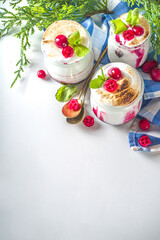 Cranberry layered Dessert breakfast in small jars for Christmas morning. Homemade baked Cranberry meringue dessert, with fresh cranberries and mint, copy space