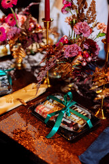 Sweet desserts in a plastic box on a decorated wedding table. Choosing a wedding cake. Cake fillings. Blurred background and selected focus.