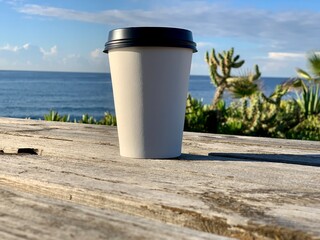 paper cup of coffee emptyon sea background