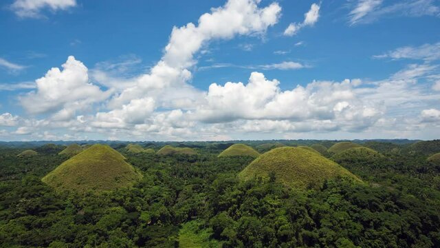 Time lapse view of blue skies over the famous Chocolate Hills on a beautiful spring day in Bohol Island, Visayas Archipelago, Philippines. 