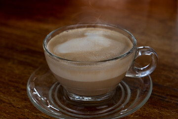 Hot coffee latte on a wooden floor