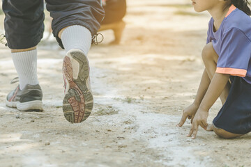 Students fitness training for sprinting on an athletic track in school.