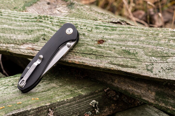 Pocket knife in folded position. Pocket knife. Clip for carrying.