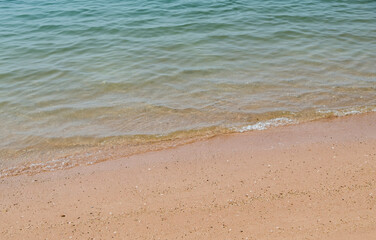 Fototapeta na wymiar Transparent clear wave on the soft beach.