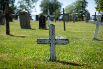 An old wooden cross on a cemetery 