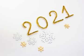 2021 number for New year greeting card. Christmas Party decoration on white background. Golden tinsel and snowflakes.