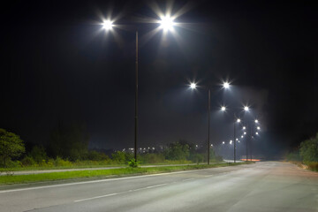 night empty road with bright LED streetlights, modern illumination