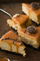 Cheesecake with salted caramel on brown  background. Copy space for text.