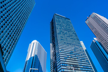 Plakat Asia, Real Estate, Corporate Construction and Business Concepts - Office Buildings and Blue Sky in Shinjuku, Tokyo, Japan