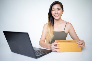 Asian women are doing online at the office.

W