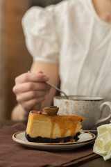 Cheesecake with caramel sauce on brown  background. Tasty homemade caramel cheesecake
