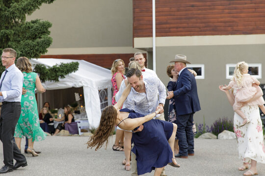 Playful wedding guests dancing at reception party