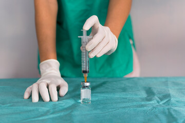 Obraz na płótnie Canvas two hands, of a young nurse, holding a vaccine sample