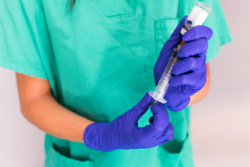 two hands, of a young nurse, holding a vaccine sample