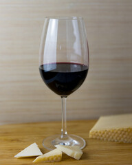 glass of the red wine with cheese