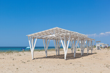 Fototapeta premium Empty shady canopy on a sparsely populated beach near the village of Vitino, Saki district, Crimea