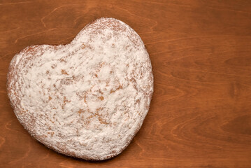 homemade heart-shaped cake dusted with powdered sugar, freshly baked for the holiday