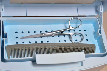 hairdressing tools in a sanitizing box for disinfecting and cleaning from bacteria and viruses in a disinfectant solution
