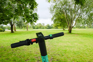electric scooter handlebar with brake and speed levers on nature background