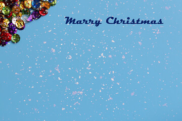 Christmas blue background with sparkles and the inscription Marry Christmas