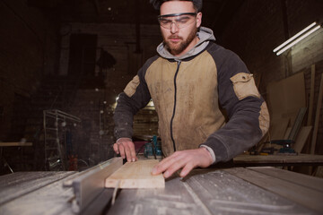 a worker processes a Board on a woodworking machine