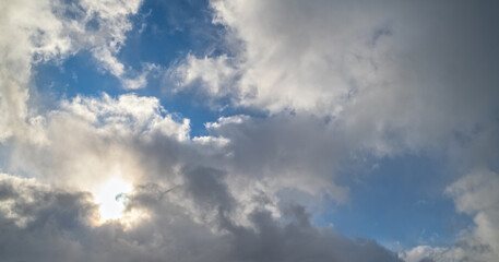 Fototapeta na wymiar Blue sky with clouds in sunlight, wide cloudscape background panorama