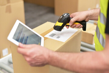 workers in the warehouse scanning parcels for retail and transport shipping - 396841330