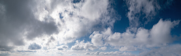 Obraz premium Blue sky with clouds in sunlight, wide cloudscape background panorama