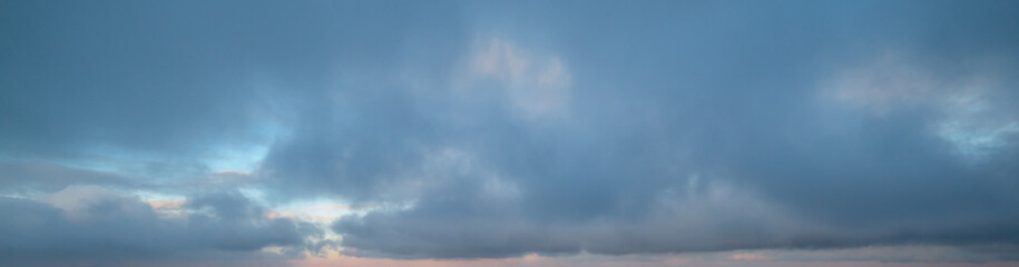 Fluffy clouds in evening overcast sky panoramic view. Climate, environment and weather concept sky...