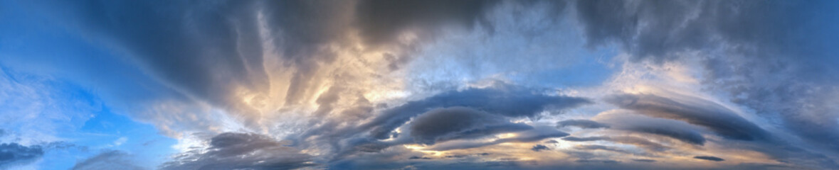 Fluffy clouds in evening overcast sky panoramic view. Climate, environment and weather concept sky background.