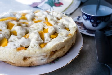 Homemade cake with fruit slices on the tea table