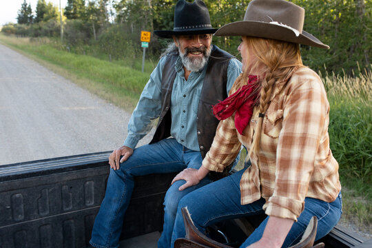 Happy Affectionate Farmer Couple Riding In Pickup Truck Bed